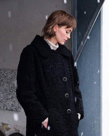 Wrap yourself in elegance with this vintage 80s 90s black real fur coat. This timeless piece adds a touch of luxury to any outfit. 