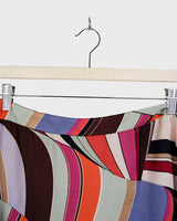 This Y2k skirt serves pure elegance with its flowing silhouette and vibrant geometric print in magenta, teal, orange, and warm brown. Light and easy to wear, it’s comfortable and anything but boring—designed for those who dress with intention.
