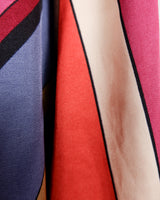 This Y2k skirt serves pure elegance with its flowing silhouette and vibrant geometric print in magenta, teal, orange, and warm brown. Light and easy to wear, it’s comfortable and anything but boring—designed for those who dress with intention.
