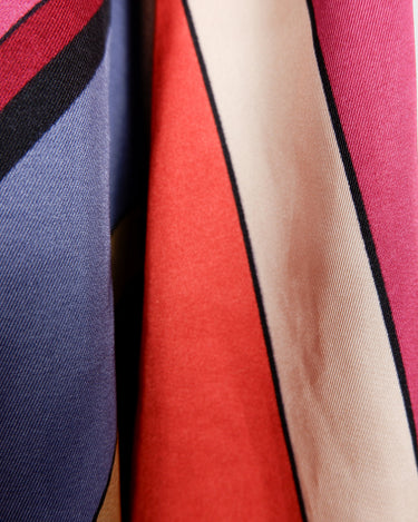 This Y2k skirt serves pure elegance with its flowing silhouette and vibrant geometric print in magenta, teal, orange, and warm brown. Light and easy to wear, it’s comfortable and anything but boring—designed for those who dress with intention.