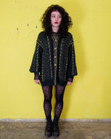 Add some sparkle to your wardrobe with this vintage 80s green cardigan, featuring eye-catching golden details. Perfect for layering and dressing up any outfit!