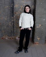 Embrace your love for cable knit with this vintage 80s 90s handknitted white sweater. Perfect for cable knit lovers, this cozy piece is a must-have.