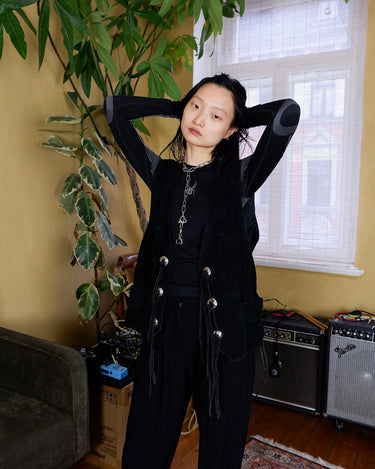 Add a cool layer to your outfit with this vintage 80s black leather vest! Made from robust suede leather, this vest is edgy and versatile. Perfect for a unique look, this vest is sure to be a staple in your wardrobe!