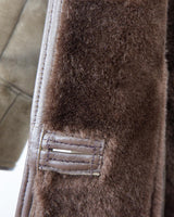 Experience the ultimate warmth and coziness in our Vintage 80s brown shearling coat! This timeless piece, available in XXS - XS, will keep you snug and stylish all winter long. Say "bye-bye" to cold weather!