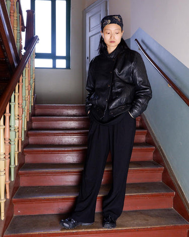 This Vintage 80s black leather jacket is the ultimate classic, complete with press buttons, structured vibes, and smooth leather.