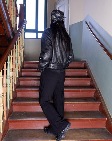 This Vintage 80s black leather jacket is the ultimate classic, complete with press buttons, structured vibes, and smooth leather.