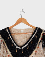 Cuddle up in this 90s vintage sweater, featuring a furry beige and dirty white design. The unique 1/2 sleeve style and attached shell add an extra touch of playful charm. We absolutely love this unique sweater! What about you?