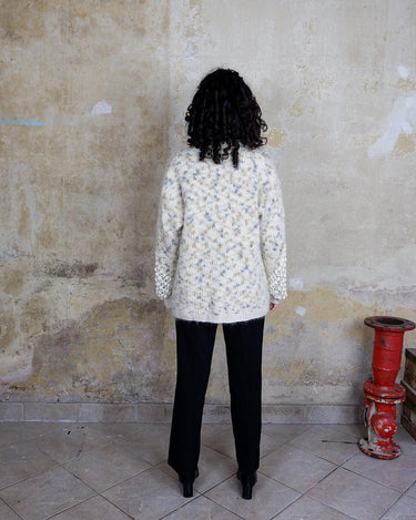 This Italian-made sweater is a premium vintage piece from the iconic 80s era. Handmade with care, this white sweater is a must-have addition to your wardrobe. 