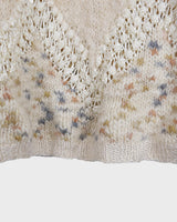 This Italian-made sweater is a premium vintage piece from the iconic 80s era. Handmade with care, this white sweater is a must-have addition to your wardrobe. 