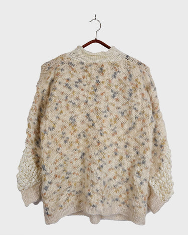 This Italian-made sweater is a premium vintage piece from the iconic 80s era. Handmade with care, this white sweater is a must-have addition to your wardrobe. 