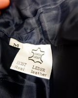 Introducing our latest obsession: a vintage 80s navy blue leather vest with unique stitching at the collar. Who doesn't love a good leather vest? Perfect for adding some edge to any outfit.