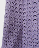 Add a pop of color to your wardrobe with this hand-crocheted purple vest. Made with love and perfect for layering, its long fit will give you an effortlessly look.