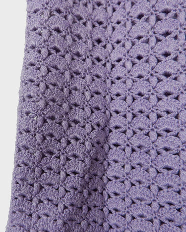 Add a pop of color to your wardrobe with this hand-crocheted purple vest. Made with love and perfect for layering, its long fit will give you an effortlessly look.