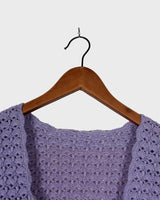 Add a pop of color to your wardrobe with this hand-crocheted purple vest. Made with love and perfect for layering, its long fit will give you an effortlessly look.