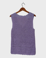 Add a pop of color to your wardrobe with this hand-crocheted purple vest. Made with love and perfect for layering, its long fit will give you an effortlessly look.