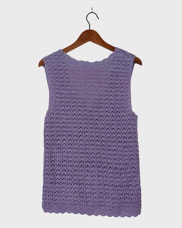 Add a pop of color to your wardrobe with this hand-crocheted purple vest. Made with love and perfect for layering, its long fit will give you an effortlessly look.