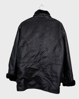 Experience timeless style with this Vintage 80s black faux leather shearling coat, featuring a warm lining that will keep you cozy. Just a heads up, the sleeves are not lined for extra warmth.
