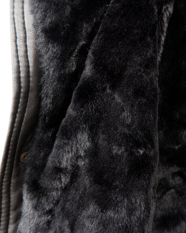Experience timeless style with this Vintage 80s black faux leather shearling coat, featuring a warm lining that will keep you cozy. Just a heads up, the sleeves are not lined for extra warmth.