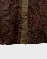 Add a touch of eccentricity to your wardrobe with this vintage 80s long brown leather fur coat. Featuring unique patchwork leather and a cozy fur lining, this XL-XXL coat is perfect for making a bold statement