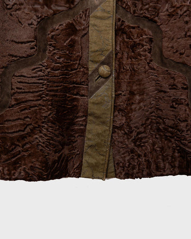 Add a touch of eccentricity to your wardrobe with this vintage 80s long brown leather fur coat. Featuring unique patchwork leather and a cozy fur lining, this XL-XXL coat is perfect for making a bold statement
