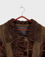 Add a touch of eccentricity to your wardrobe with this vintage 80s long brown leather fur coat. Featuring unique patchwork leather and a cozy fur lining, this XL-XXL coat is perfect for making a bold statement