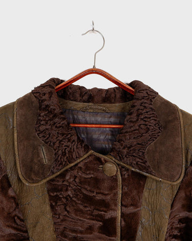 Add a touch of eccentricity to your wardrobe with this vintage 80s long brown leather fur coat. Featuring unique patchwork leather and a cozy fur lining, this XL-XXL coat is perfect for making a bold statement
