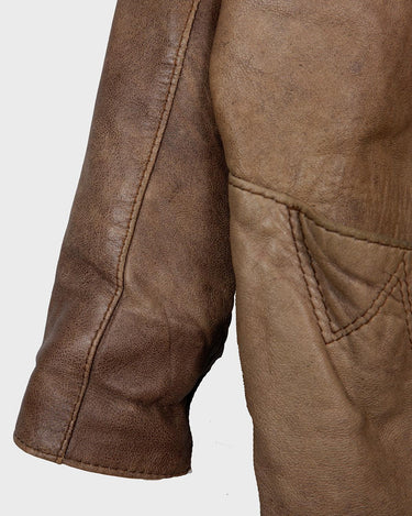 Introducing our must-have Vintage 80s brown/beige leather jacket (used look). It features shoulder pads for a structured look and adds a touch of 80s style to any wardrobe.