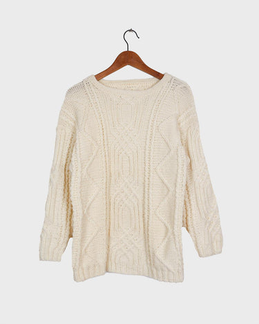 Embrace your love for cable knit with this vintage 80s 90s handknitted white sweater. Perfect for cable knit lovers, this cozy piece is a must-have.
