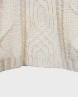 Embrace your love for cable knit with this vintage 80s 90s handknitted white sweater. Perfect for cable knit lovers, this cozy piece is a must-have.