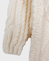 Embrace your love for cable knit with this vintage 80s 90s handknitted white sweater. Perfect for cable knit lovers, this cozy piece is a must-have.