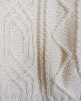 Embrace your love for cable knit with this vintage 80s 90s handknitted white sweater. Perfect for cable knit lovers, this cozy piece is a must-have.