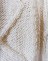 Embrace your love for cable knit with this vintage 80s 90s handknitted white sweater. Perfect for cable knit lovers, this cozy piece is a must-have.