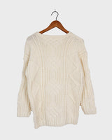 Embrace your love for cable knit with this vintage 80s 90s handknitted white sweater. Perfect for cable knit lovers, this cozy piece is a must-have.