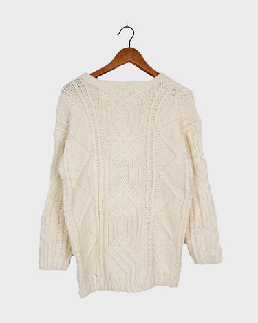 Embrace your love for cable knit with this vintage 80s 90s handknitted white sweater. Perfect for cable knit lovers, this cozy piece is a must-have.