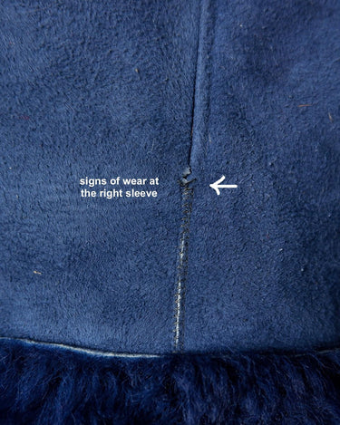Cozy up like it's the 80s with this vintage navy blue shearling coat. Perfect for colder days! Get your winter fashion game on point.