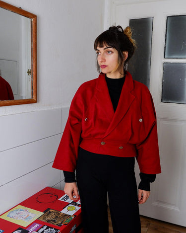 This XS Vintage 80s red wool jacket boasts a timeless and classic appeal with its unique double rows button design. Crafted with high-quality wool fabric, this jacket exudes a refined look.