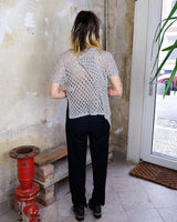Preloved and handmade, this silver crochet top catches the light with its soft shimmer. The open-knit design and asymmetrical cut give it that effortless, worn-in feel. A rare find that’s easy to style and full of character.