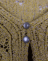Add some playful personality to your wardrobe with this handmade beige and shimmering yellow cardigan. The light crop fit makes it perfect for layering over any outfit.