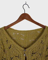 Add some playful personality to your wardrobe with this handmade beige and shimmering yellow cardigan. The light crop fit makes it perfect for layering over any outfit.