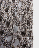 Preloved and handmade, this silver crochet top catches the light with its soft shimmer. The open-knit design and asymmetrical cut give it that effortless, worn-in feel. A rare find that’s easy to style and full of character.