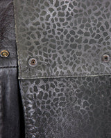 This vintage 80s coat features a fierce black animal print, adding a unique touch to any outfit. The belted waist cinches in for a flattering fit, making you feel confident and channeling your inner wild side.