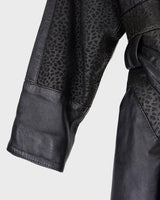 This vintage 80s coat features a fierce black animal print, adding a unique touch to any outfit. The belted waist cinches in for a flattering fit, making you feel confident and channeling your inner wild side.