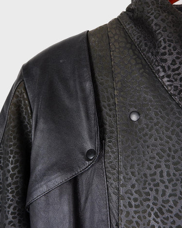 This vintage 80s coat features a fierce black animal print, adding a unique touch to any outfit. The belted waist cinches in for a flattering fit, making you feel confident and channeling your inner wild side.