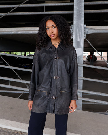 Vintage 80s black fireman clasp leather coat with light shoulder pads | L-XL