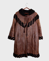 Looking for a statement piece? Look no further! This Vintage 80s brown leather coat with black real fur is a versatile addition to any wardrobe. Its unique design and edgy style make it perfect for you!