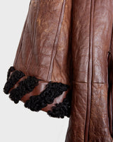 Looking for a statement piece? Look no further! This Vintage 80s brown leather coat with black real fur is a versatile addition to any wardrobe. Its unique design and edgy style make it perfect for you!
