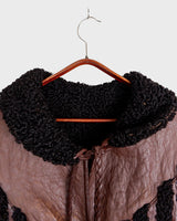 Looking for a statement piece? Look no further! This Vintage 80s brown leather coat with black real fur is a versatile addition to any wardrobe. Its unique design and edgy style make it perfect for you!