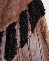 Looking for a statement piece? Look no further! This Vintage 80s brown leather coat with black real fur is a versatile addition to any wardrobe. Its unique design and edgy style make it perfect for you!