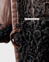 Looking for a statement piece? Look no further! This Vintage 80s brown leather coat with black real fur is a versatile addition to any wardrobe. Its unique design and edgy style make it perfect for you!