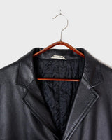 Introducing our Vintage 90s black long leather button coat! Timeless, sleek, and classic, this coat is the perfect addition to any wardrobe. Featuring a button closure, it exudes elegance.